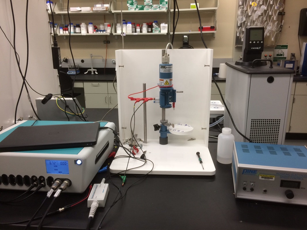 a lab table with an electrochemical station set up